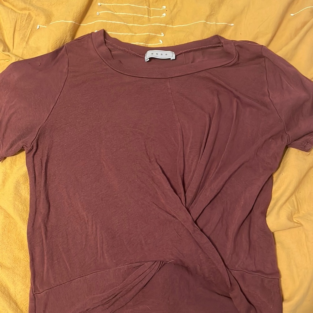 Dark red tee with a crossing design